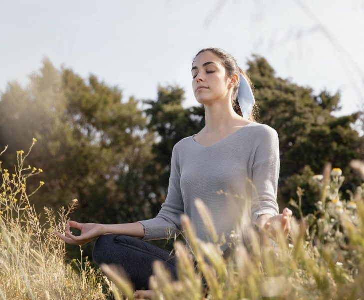 mujer-joven-meditando-en-la-naturaleza
