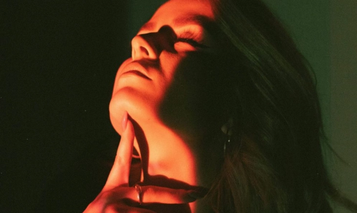 Mujer iluminada por una luz cálida, símbolo del tratamiento contra la flacidez en la menopausia y del poder de cuidarse sin culpa