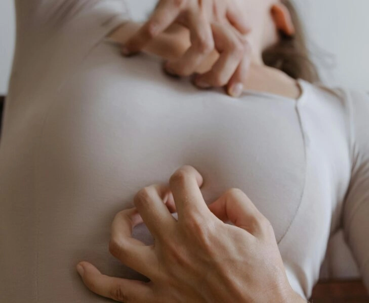 Mujer rascándose la piel irritada, causada por un desequilibrio en la microbiota cutánea y la alimentación