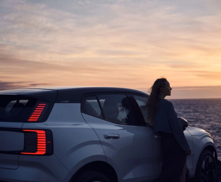 estres conducir VOLVO 2 Mujer cerca de un coche, reduciendo ansiedad al volante